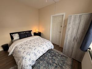 a bedroom with a bed and a cabinet and a rug at Cosy Heavens in Quinton