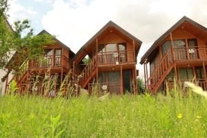 a house in the middle of a field of grass at BUJTINA IZET SELIMAj in Valbonë