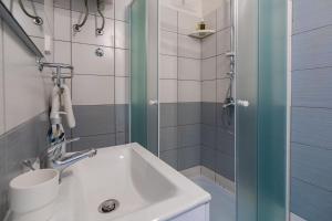 a bathroom with a sink and a shower at Lumina Apartments in Korčula