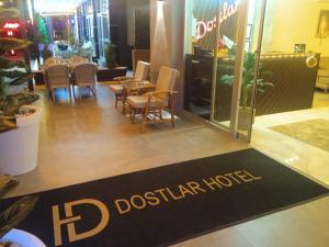 a restaurant with a table and chairs and a floor mat at Dostlar Hotel in Mersin