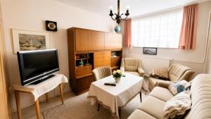 a living room with a couch and a tv at unterkunft Cuxhaven in Cuxhaven