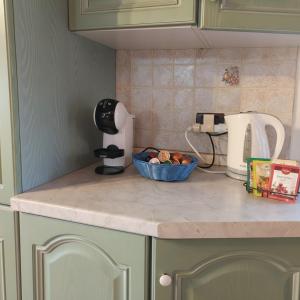a kitchen counter with a bowl of fruit and a mixer at Rustic Refuge in the Hills in Santa Luce