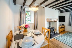 a dining room with a table and a fireplace at 2 Bed in Pwllheli oc-44492 in Nefyn