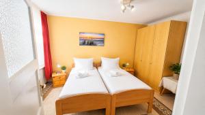 a bedroom with a bed with white sheets at unterkunft Cuxhaven in Cuxhaven