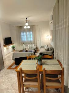 a living room with a table and chairs and a couch at Captain's House in Filiatra