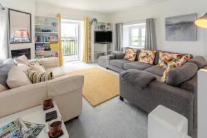a living room with two couches and a television at 2 Bed in St. Minver oc-r29475 in Saint Minver