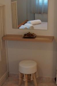 a stool sitting on a shelf with a mirror at Captain's House in Filiatra +24 photos