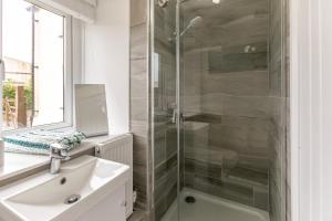 a bathroom with a shower and a sink and a mirror at 2 Bed in St. Minver oc-r29475 in Saint Minver +30 photos