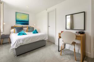 a bedroom with a bed and a desk and a chair at 2 Bed in St. Minver oc-r29475 in Saint Minver