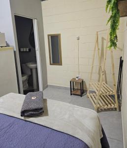 a room with a bed and a bathroom with a toilet at Kitnet Completa em Cotia com Garagem 04 in Cotia +17 photos