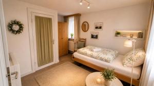 a small bedroom with a bed and a table at unterkunft Cuxhaven in Cuxhaven +1 photo