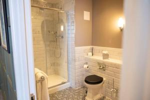 a bathroom with a shower and a toilet and a sink at The Globe, Warwick, Warwickshire - Brunning & Price in Warwick +49 photos