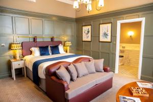a bedroom with a large bed and a couch at The Globe, Warwick, Warwickshire - Brunning & Price in Warwick