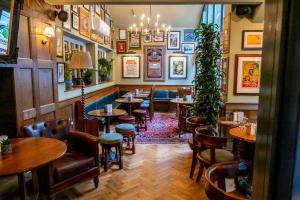 a bar with tables and chairs in a restaurant at The Globe, Warwick, Warwickshire - Brunning & Price in Warwick
