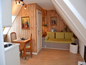 a living room with a yellow couch and a table at Haus Seeflieger in Westerland