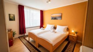 a bedroom with a large bed with orange walls at unterkunft Cuxhaven in Cuxhaven