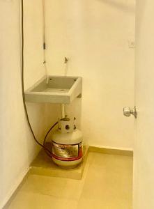 a bathroom with a sink and a bucket under it at Studio Cangrejos in Los Médanos Partidos
