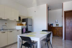 a kitchen with a white table and chairs in it at La Parentesi in Salerno +11 photos