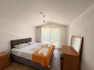 a bedroom with a large bed and a mirror at Olivra Apart in Cedit