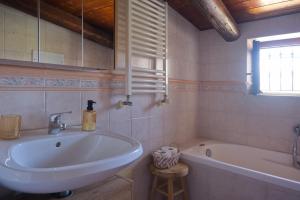 a bathroom with a tub and a sink and a bath tubermottermott at La Parentesi in Salerno