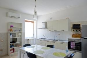 a kitchen with a table and some chairs in it at La Parentesi in Salerno