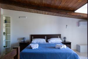 a bedroom with a blue bed with towels on it at La Parentesi in Salerno