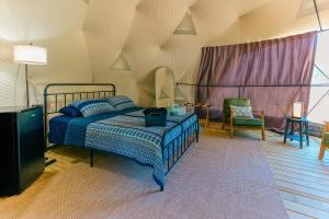 a bedroom with a bed and a tv in it at Cozy Mountain Dome Escape in the Catskills in Gilboa