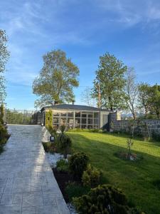 a house with a garden in front of a building at Villa suit in Trabzon