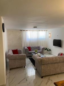 a living room with two couches and a tv at W3 property in Kerak +13 photos