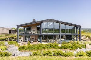 a large glass house with a roof at The Retreat at Strashleigh Manor Farm - A Luxury Devon Country Escape in Ivybridge