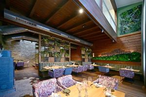 a dining room with tables and purple chairs at Wald & Wiese Hornstein in Hornstein