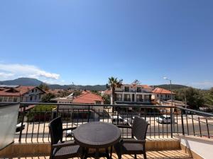 a patio with a table and chairs on a balcony at Olivra Apart in Cedit +5 photos