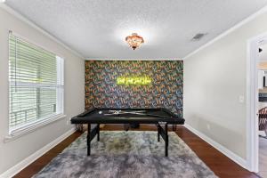 a ping pong table in a room with a wall at Putt Putt Pool Home - Mini Golf Grill Ping Pong in Jacksonville