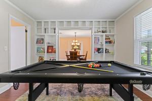 a pool table in a living room with a billiard at Putt Putt Pool Home - Mini Golf Grill Ping Pong in Jacksonville +41 photos