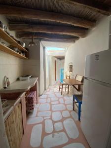 a kitchen with a refrigerator and a table at Evnomia Cycladic Home from 1912 in Mélanes +38 photos
