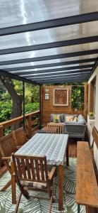 a patio with a table and chairs and a couch at Bike & Chill Apartment in Balatonfüred
