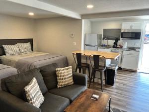 a living room with a bed and a couch and a table at Snowy Mountain Inn in Saratoga