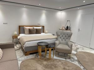 a bedroom with a bed and a chair and a couch at Eliasar1 in Linz
