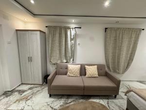 a living room with a couch and two windows at Eliasar1 in Linz
