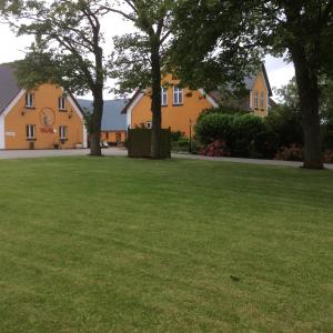 a large grassy yard with a house in the background at AD Apartment in Køge