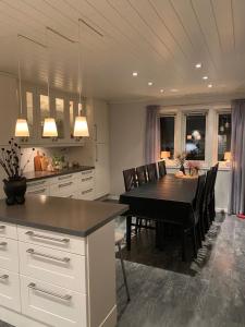 a kitchen with a table and a dining room at Yttermoveien in Narvik
