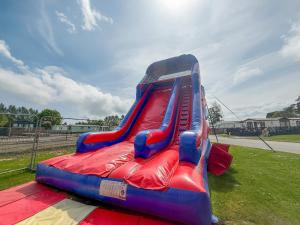 a red and blue slide on a playground at 20 The Green, Lilliardsedge in Jedburgh