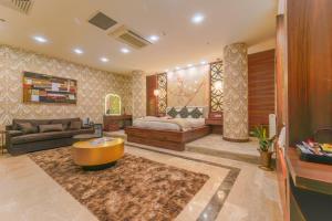 a living room with a couch and a table at Grand Canyon Hotel in Ankara