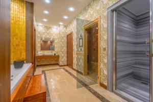 a bathroom with a walk in shower and a tub at Grand Canyon Hotel in Ankara