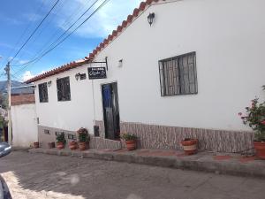 a white house with a window and a door at Hostal familiar Shambala in Silos