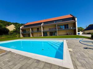 a house with a swimming pool in front of a house at Vinopool Suites Badacsony in Badacsonytomaj +30 photos