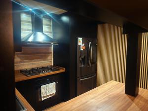 a kitchen with a stove and a refrigerator at Mary y Luis in Coihaique