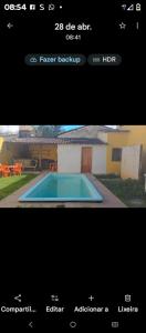 a screenshot of a page of a house with a swimming pool at Hospedagem da Paty in Ilhéus