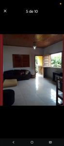 a living room with a bed and a table at Hospedagem da Paty in Ilhéus