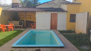 a swimming pool in the backyard of a house at Hospedagem da Paty in Ilhéus